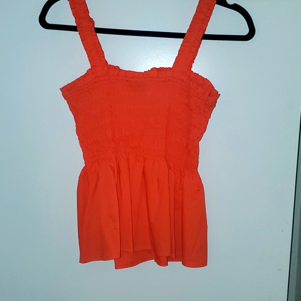Very cute orange peplum top. Never worn.